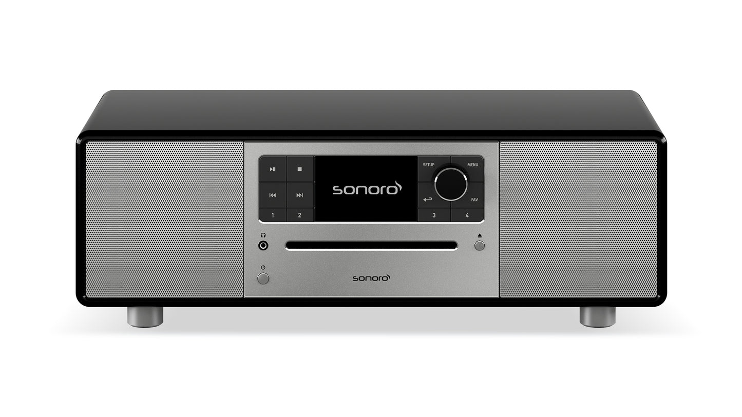Der Sonoro Prestige in hochglänzendem Schwarz-Silber besticht durch digitales Display, Bedienknöpfe, Tasten und zwei Frontlautsprecher für exzellente Akustik - stilvoll auf vier kurzen Beinen.