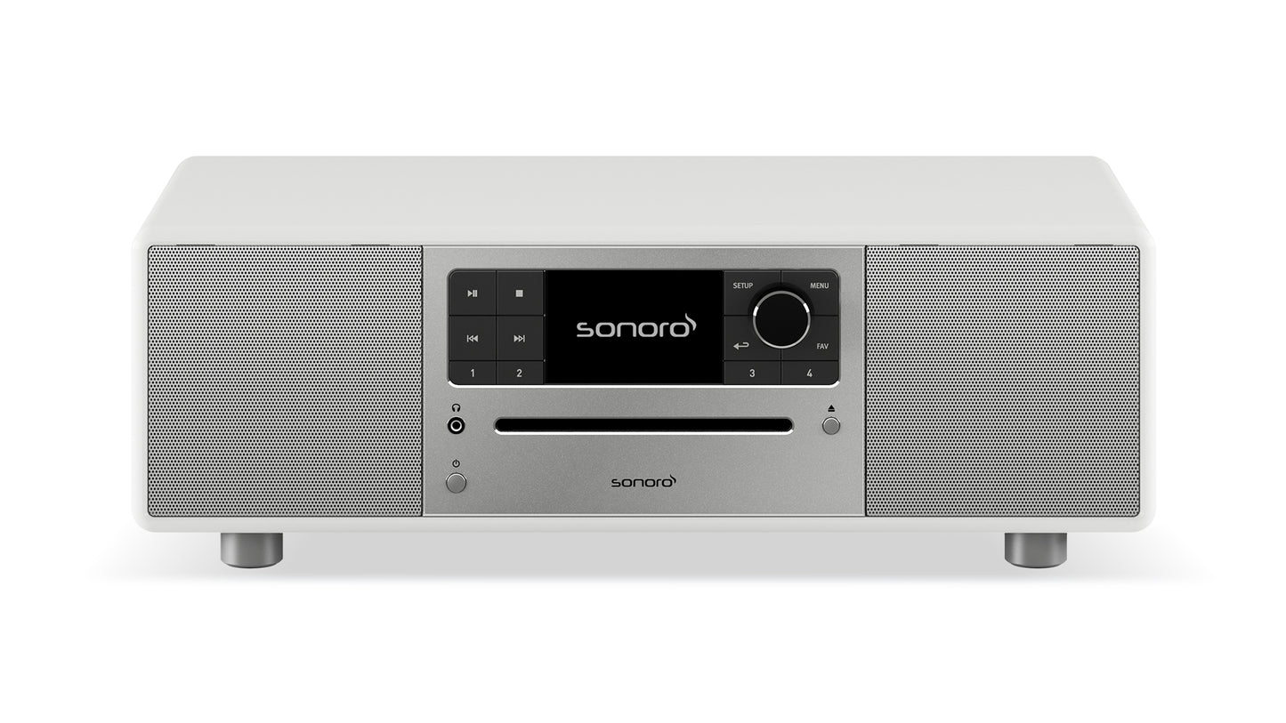 Das Sonoro Prestige Audiosystem in Weiß (hochglänzend)-Silber bietet seitliche Lautsprecher, zentrale Bedienknöpfe, Display und Lautstärkeregler - perfekt für exzellente Akustik und vielfältige Musikquellen.