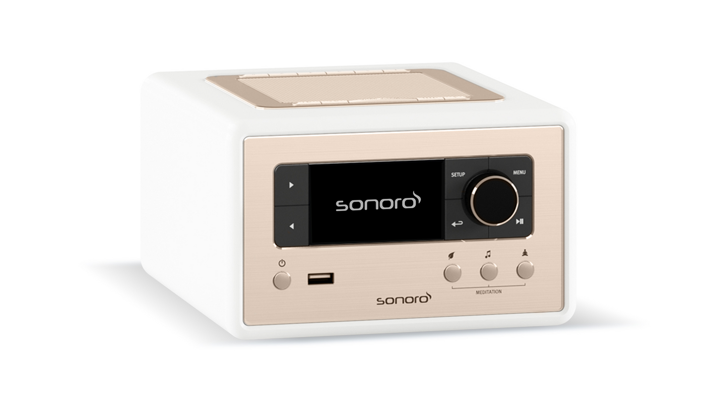 Der Sonoro Relax in Weiß (matt) - Rosé verfügt über ein digitales Display, Bedientasten, USB-Anschluss und ein oberes Lautsprechergitter - perfekt für Wellness und Entspannung bei Meditationsübungen.