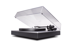 Der Cambridge Audio Alva TT V2 Plattenspieler in Grau bietet eine transparente, teilweise geöffnete Staubabdeckung, einen schlanken Sockel, MC-Tonabnehmer und hochauflösendes Bluetooth. Der Tonarm ist zum Abspielen über dem Plattenteller positioniert.