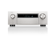 Ein silberner Denon AVC-X6800H AV-Receiver mit integriertem HEOS, digitalem Display, das Blu-ray und Dolby Atmos anzeigt, und zwei großen Bedienelementen sowie Tasten auf der Vorderseite.