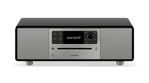 Der Sonoro Prestige in hochglänzendem Schwarz-Silber besticht durch digitales Display, Bedienknöpfe, Tasten und zwei Frontlautsprecher für exzellente Akustik - stilvoll auf vier kurzen Beinen.